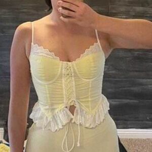 Yellow corset top with white lace detail